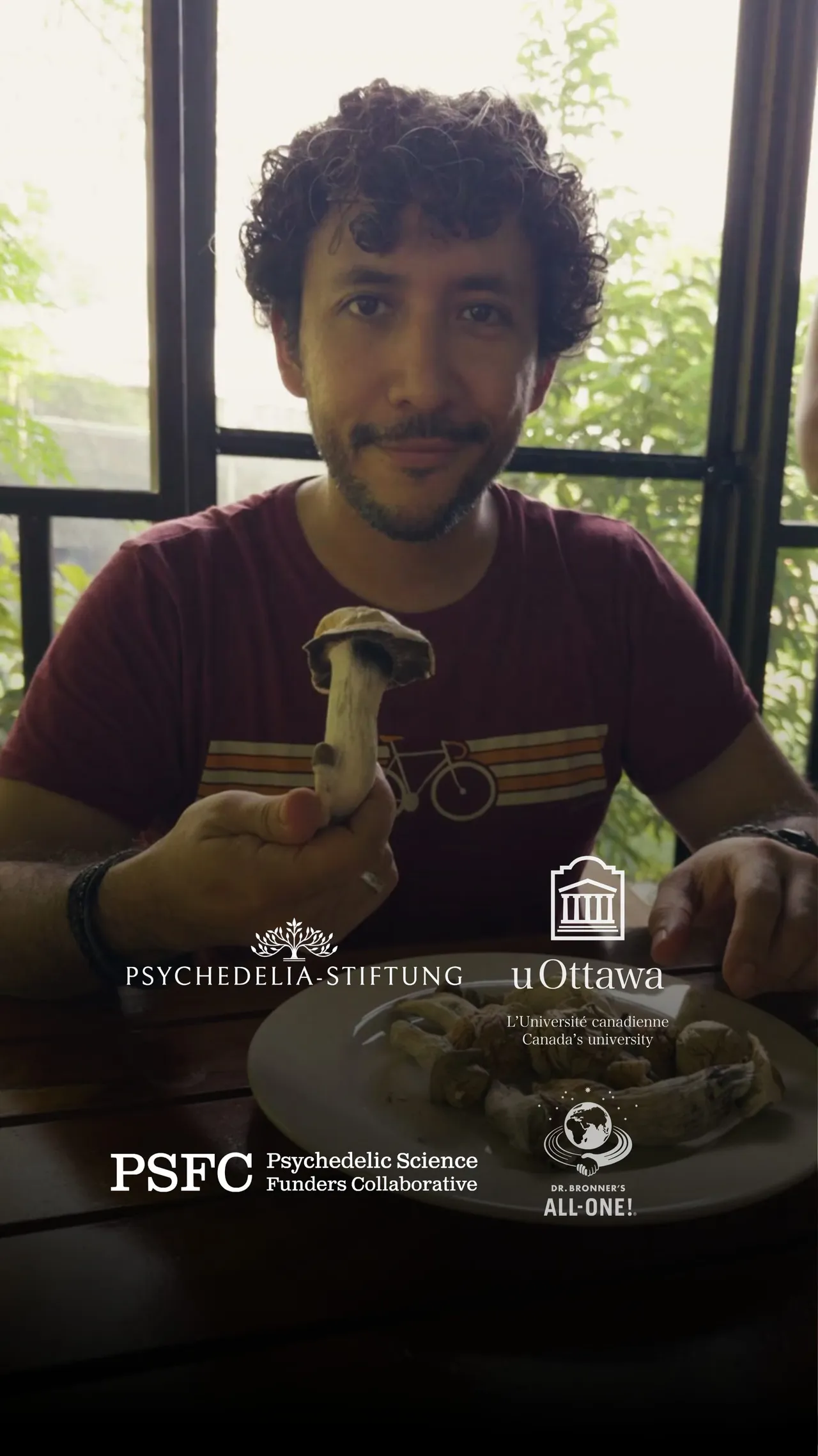 Co-founder holding a mushroom, photographed in Jamaica