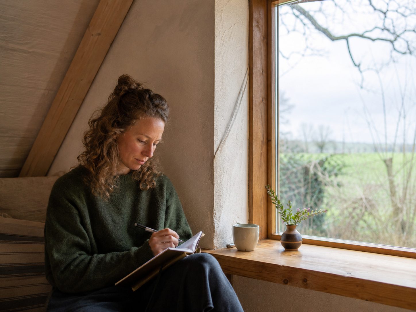 Woman journaling by the window